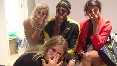 Usain Bolt celebrates his win with a group of stunning Swedes