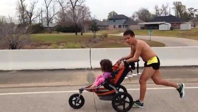 Dad with brain cancer wins marathon while pushing daughter in buggy