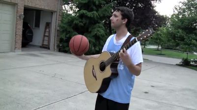 Video: Can you play a guitar while dribbling a basketball? This guy can…