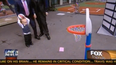 Video: FOX News reporter throws basketball at baby’s face… kind of