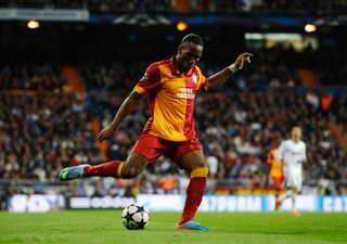 Didier Drogba meets a fan with a very interesting tattoo of him