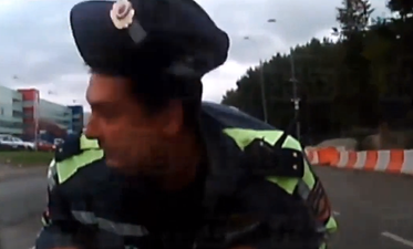 Video: Russian cop gets taken for a ride on the hood of a car