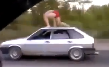 Video: Russian bloke goes surfing on top of a speeding car