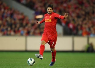 Picture: Luis Suarez brings his newborn baby on to the Anfield pitch