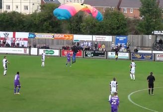 “He dived ref!” – Parachutist bizarrely lands on football pitch in the middle of game