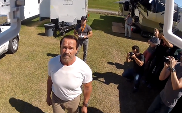 Video: Arnold Schwarzenegger gets pre-lit cigar flown in via helicopter