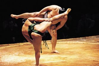 GIF: Ever seen a sumo wrestling ref take a somersault kick to the face? Right this way