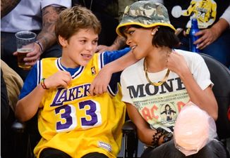 This young lad looked delighted to be sitting next to Rihanna at the Lakers game