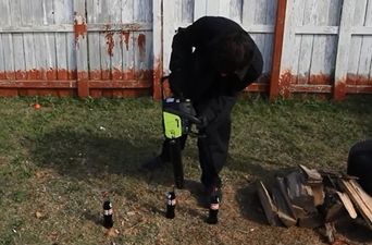 Video: Why use a bottle opener to open a bottle of beer when you can use a chainsaw instead?