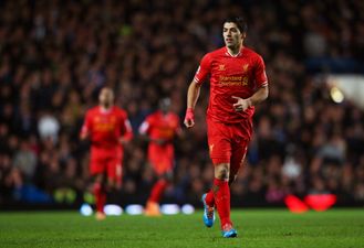 Picture: Luis Suarez stops to play football in the park with young fan who has Down Syndrome