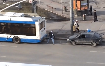 Video: Watch as two Russian guys attempt to hitch a broken down car to a public bus