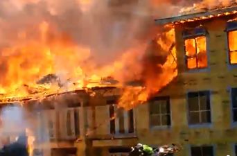 Video: Fire crews stage incredibly dramatic rescue of construction worker from burning apartment building in Texas