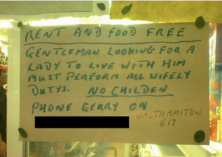 Pic: Man puts a sign up in a shop window looking for a woman to do ‘wifely dutys’