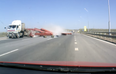 Video: Truck spills load into oncoming traffic