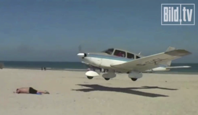 Video: Plane lands perilously close to sleeping sunbather’s head