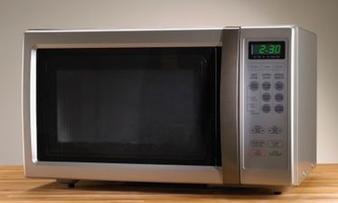 Video: Two idiots almost decapitate themselves with a flying microwave