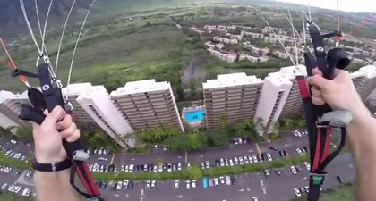 Video: Heart in mouth stuff as extreme paraglider just makes it between two buildings