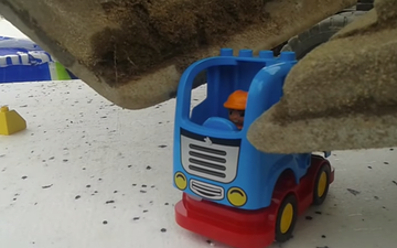 Video: This guy expertly builds tiny Lego vehicles using a massive digger