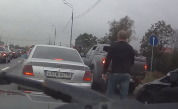 Video: Raged Russian driver turns into pussy cat when confronted by burly dog