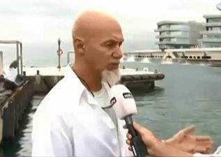 Video: Man attempting to take selfie in the background of live news report slips and falls into the sea