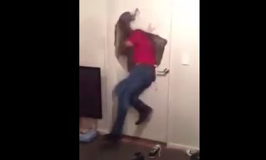Video: English international rugby player running through a door at a house party