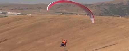 Video: Nothing to see here… Just a man paragliding on a Harley-Davidson