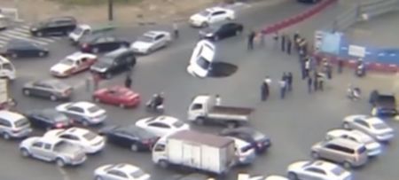 Video: Two men narrowly escape car as sinkhole terrifyingly swallows up their vehicle in China