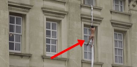 Video: Insane footage of a naked man climbing down the side of Buckingham Palace and falling