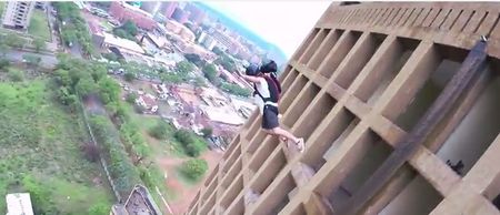 Video: Base jumpers film a race to the top of a tower block and back down again