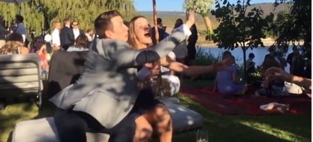 Video: Brave man actually slaps the bridal bouquet away from his girlfriend before she catches it