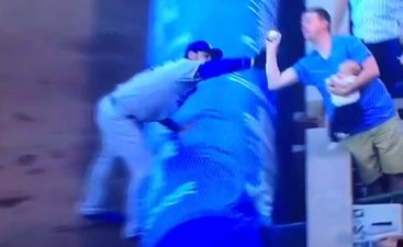 Video: Super-cool Dad makes one-handed catch at baseball game, all while feeding his baby
