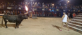 Video: Man taunts a bull with flaming horns and predictably gets gored