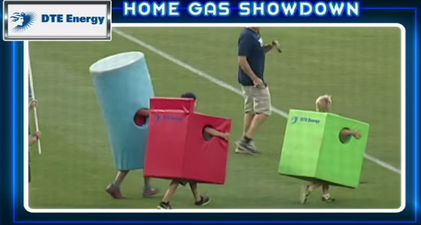 Kids dressed as household appliances race across a baseball field