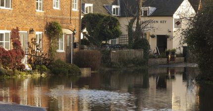 PIC: Two pub goers don’t give a sh*t about floods around them, stay drinking anyway