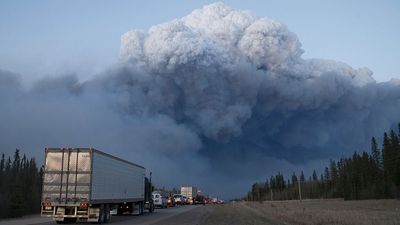 Thousands airlifted to safety as massive fire continues to cause devastation in Canada