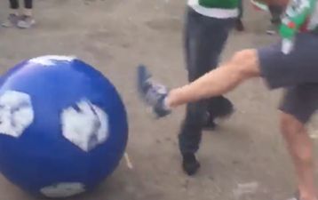 WATCH: Irish fan in Paris climbs into giant football, gets rolled around by Irish and Swedish fans