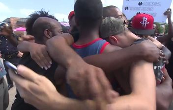 VIDEO: Rival protesters meet in Dallas and join forces in a touching show of unity