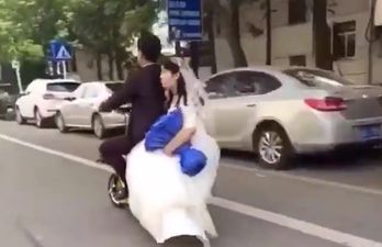 WATCH: Newlyweds go on romantic scooter ride, bride falls off, groom just keeps on going