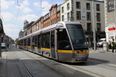 A tour bus has crashed into the Luas in Dublin city centre