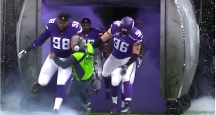 WATCH: Sound guy gets absolutely clobbered by charging NFL players, takes it like a boss