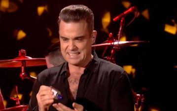 WATCH: Grimacing Robbie Williams uses hand-sanitiser immediately after touching audience at NYE gig