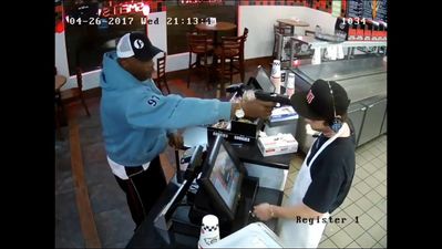 WATCH: This cashier couldn’t look less bothered about having a gun shoved in his face