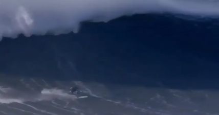 Surfer breaks back as a result of wipeout caused by giant 60-foot wave