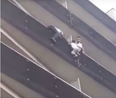 Heroic man climbs up apartment building to save child hanging from balcony