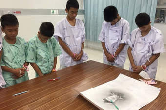 Thai boys rescued from flooded cave mourn diver who died during mission to save them