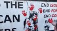 Friends of Lyra McKee stamp red handprints on dissident republican office
