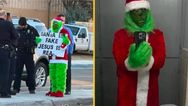 Grinch stands outside primary school with ‘Santa is fake’ sign